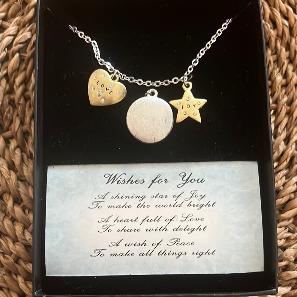 NWT Nexklace with 3 charms in gold and silver metals. Missing plastic cover.